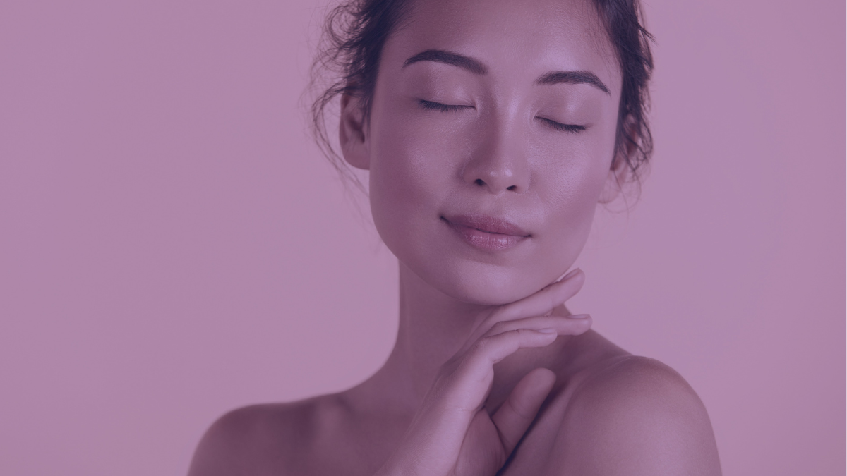 A woman with a clean face prepped and ready to apply makeup on here face.